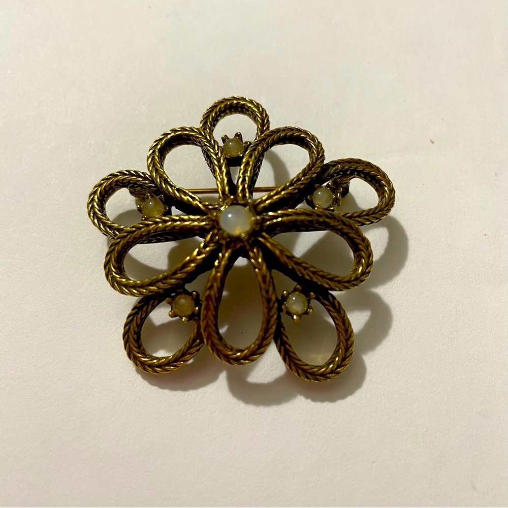 Vintage gold toned braided pin/brooch with opal looking stones.